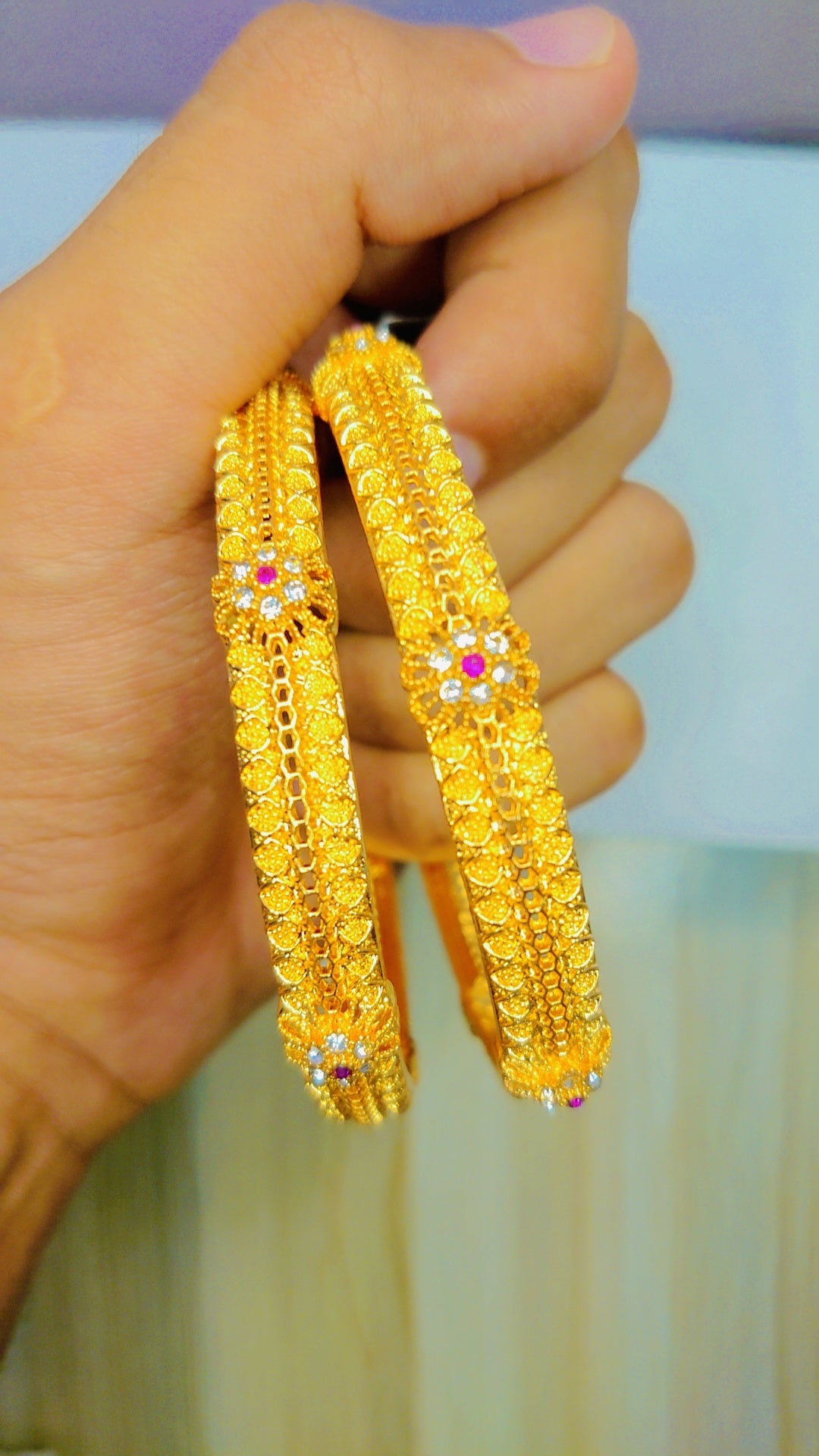 Gold-toned bangles with white zircon stones – stylish and adjustable jewelry accessory for women in Pakistan.