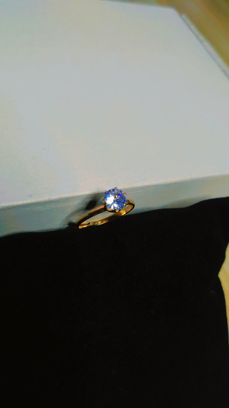 Adjustable gold ring with a bold blue zircon center – part of Zivaya’s affordable zircon jewelry sets."

